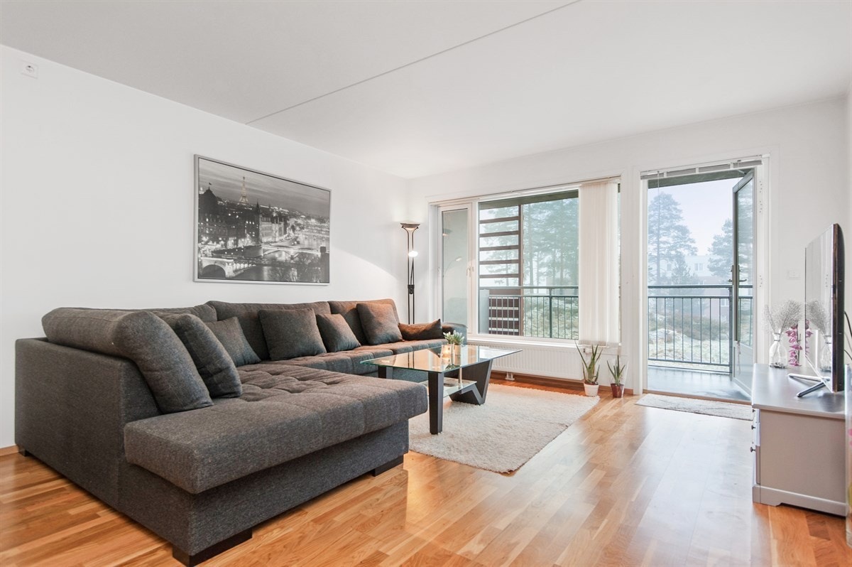 Lysmalt stue og store vindusflater sørger for at stuen oppleves luftig og lys. Galleribilde