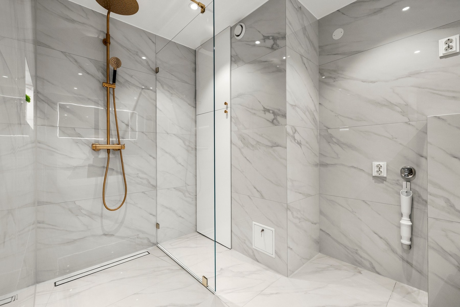 Det er gulvvarme og nedsenket himling med downlights. Lekre fliser i storformat gir et eksklusivt preg. Galleribilde