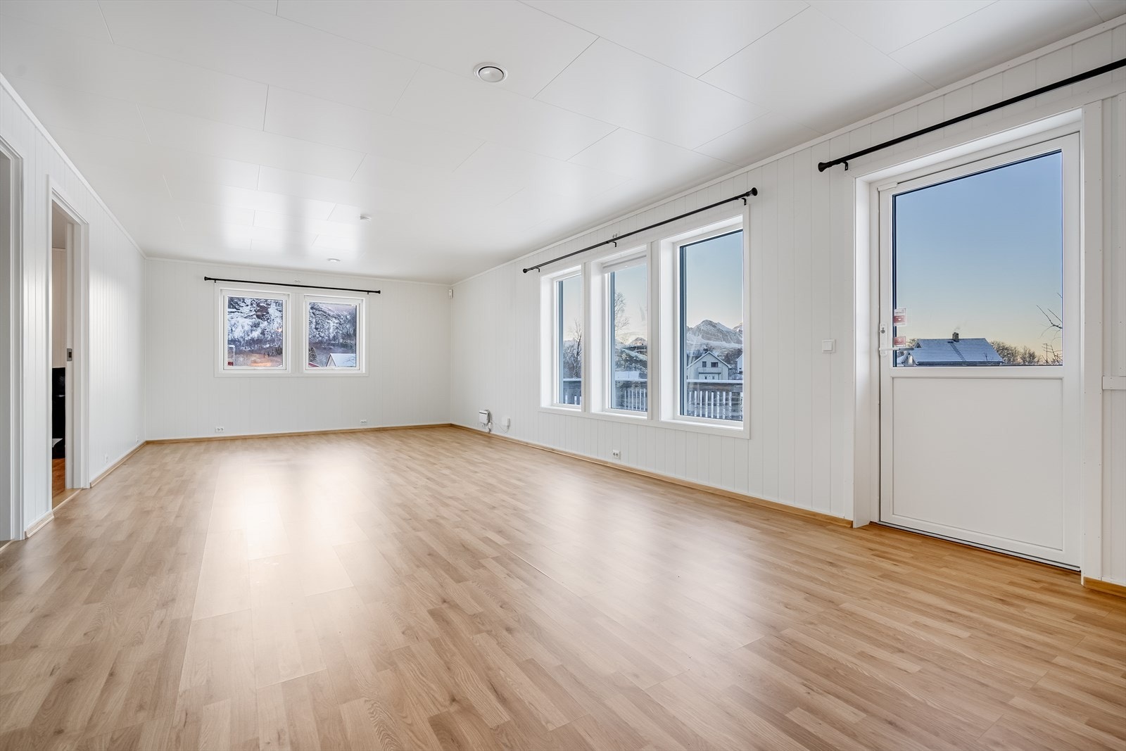 Lys og romslig stue med god plass til flere sittegrupper Galleribilde