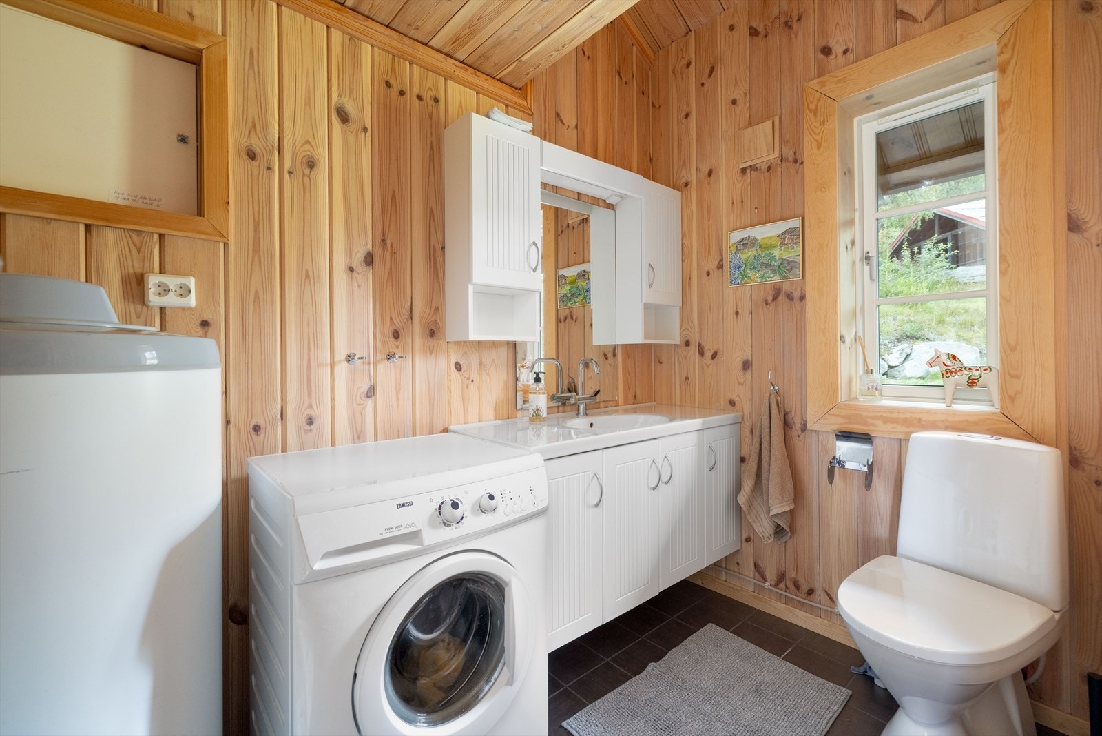 Kombinert toalett- og vaskerom med varmekabler, toalett og opplegg vaskemaskin, samt servantinnredning. Bereder på 200 liter. Galleribilde