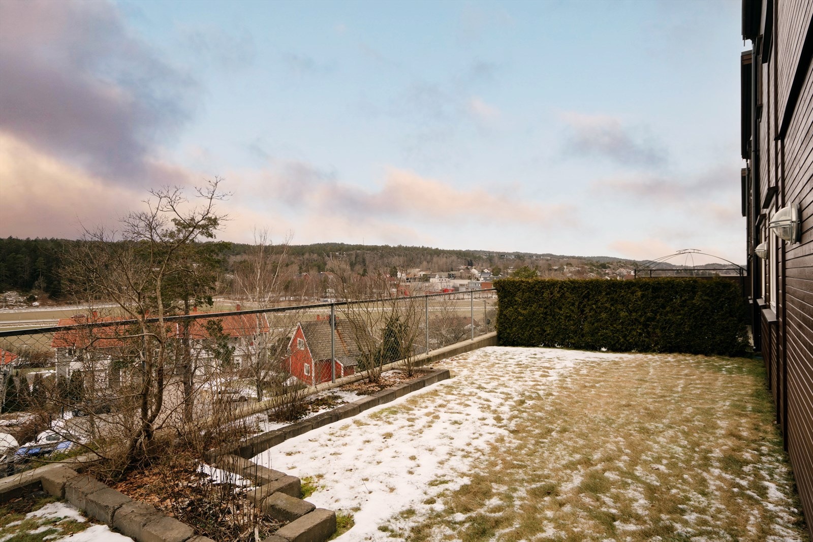 Uteområdet er opparbeidet med plen og hekk, og grenser mot fellesarealer. Galleribilde