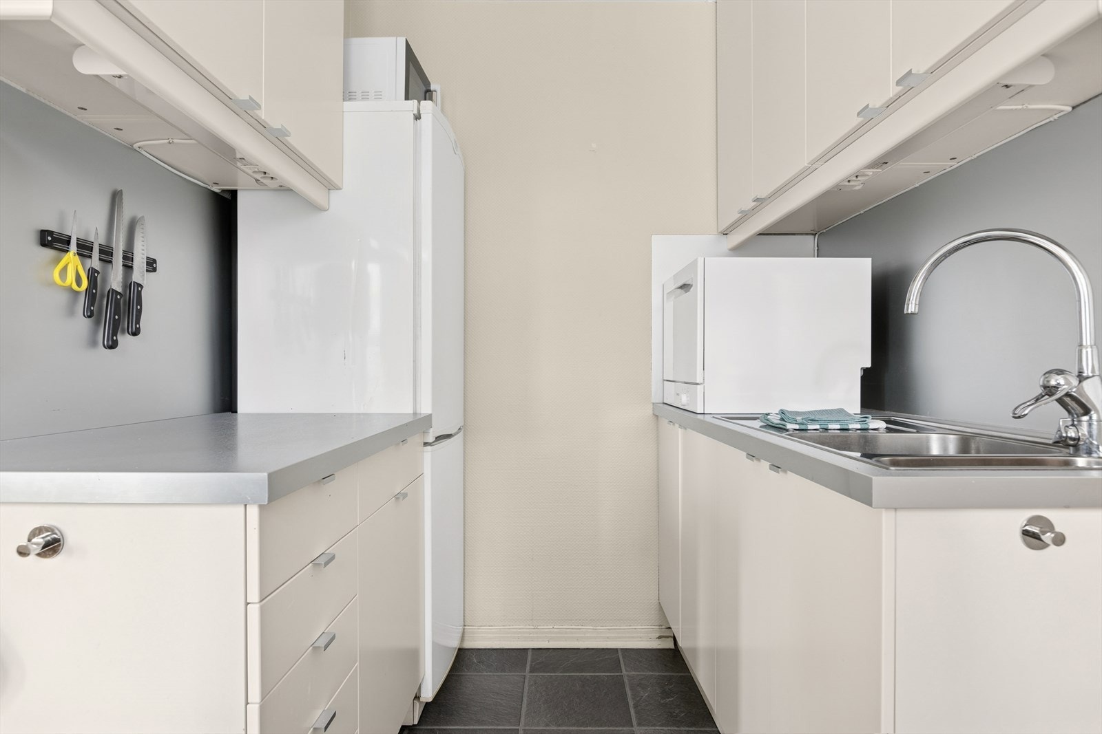 Kjøkkenet har god arbeidsbenk på begge sider som er praktisk ved matlaging. Oppvaskmaskin på benk. Galleribilde