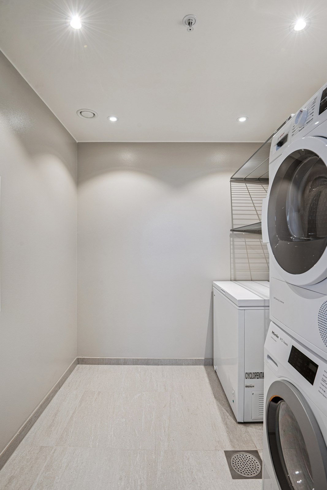 Vaskerommet har flislagt gulv og utslagsvask. Galleribilde