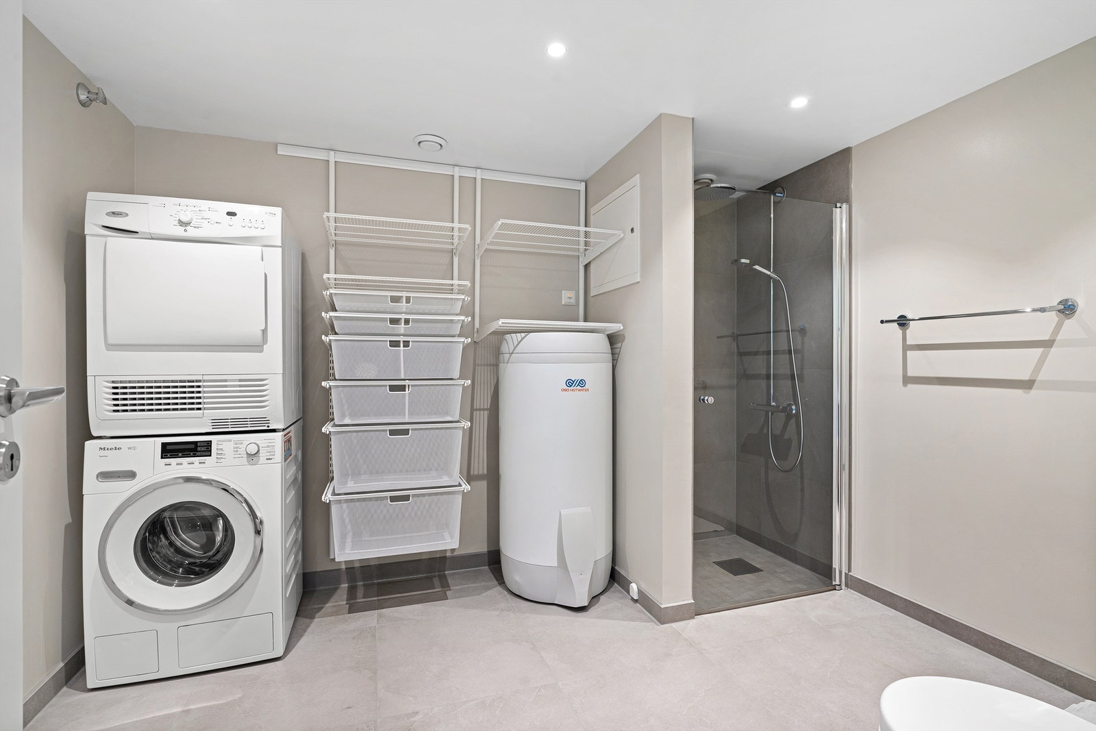 God plass til vaskemaskin og tørketrommel. Mulighet for å sette inn en skyvedør som skjuler vaskemaskin og tørketrommel på en stilren måte. Galleribilde