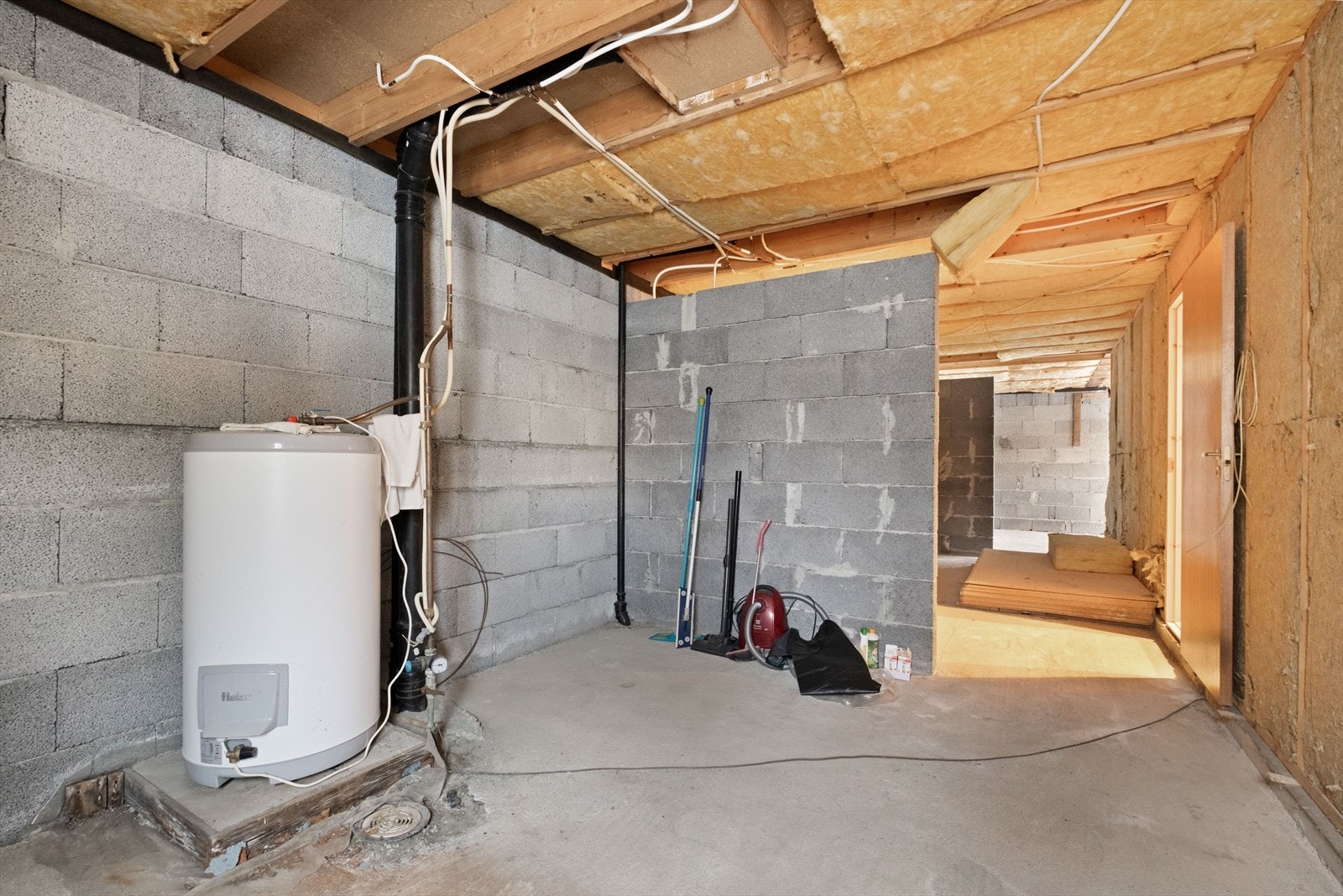 Betongvegger og uisolert gulv i underetasjen gir mulighet for tilpasninger. Varmtvannsbereder er plassert i rommet. Galleribilde