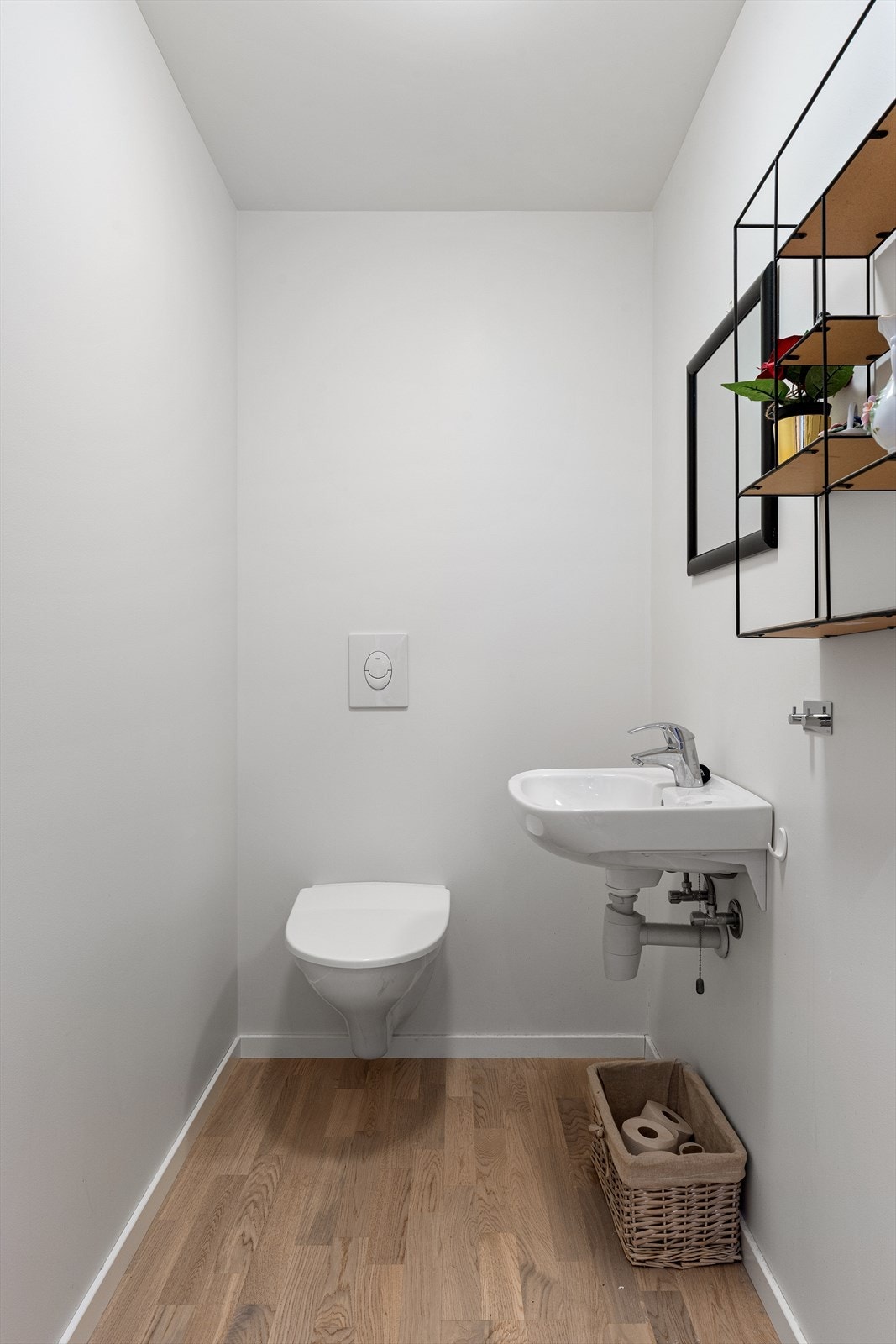 Toalettrom med vegghengt toalett og servant. Galleribilde