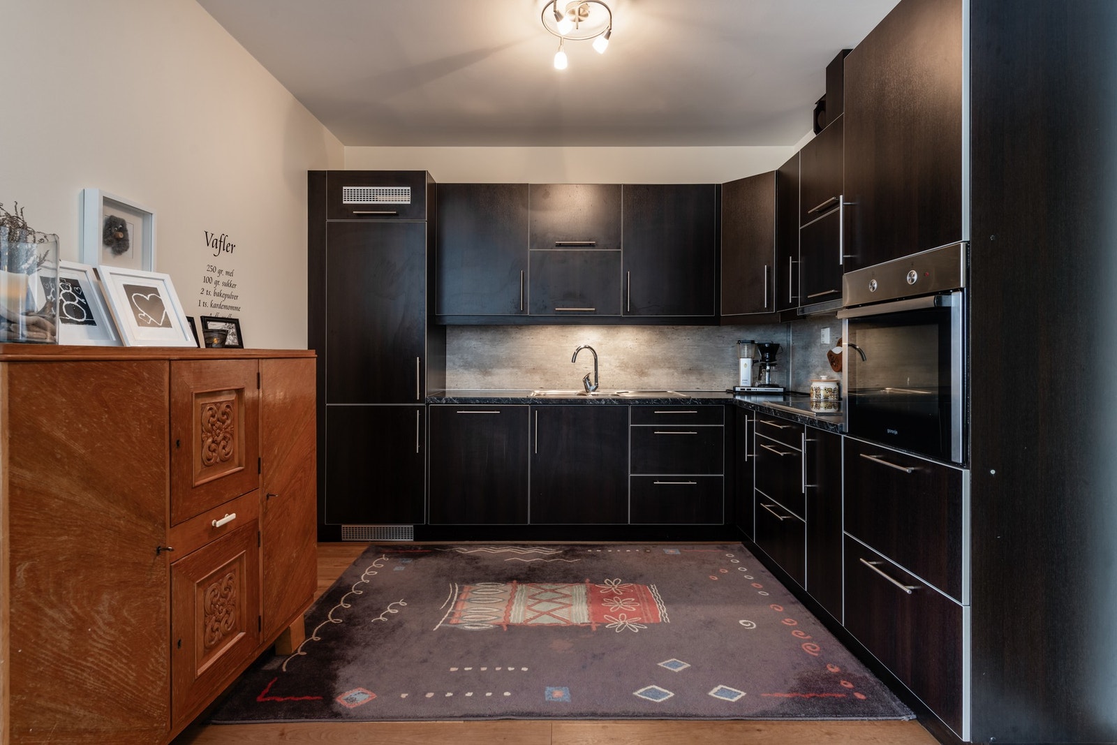 Stilig kjøkken med integrerte hvitevarer som oppvaskmaskin, stekeovn, koketopp og kjøl/frys Galleribilde