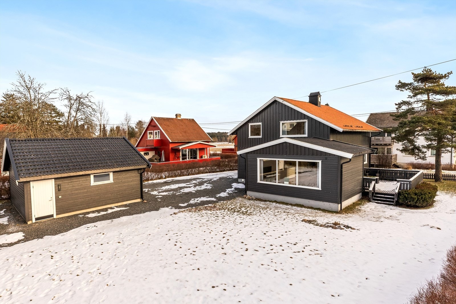 Eiendommen har en stor, gruset gårdsplass og en dobbelgarasje oppført i 2012/2013. Galleribilde