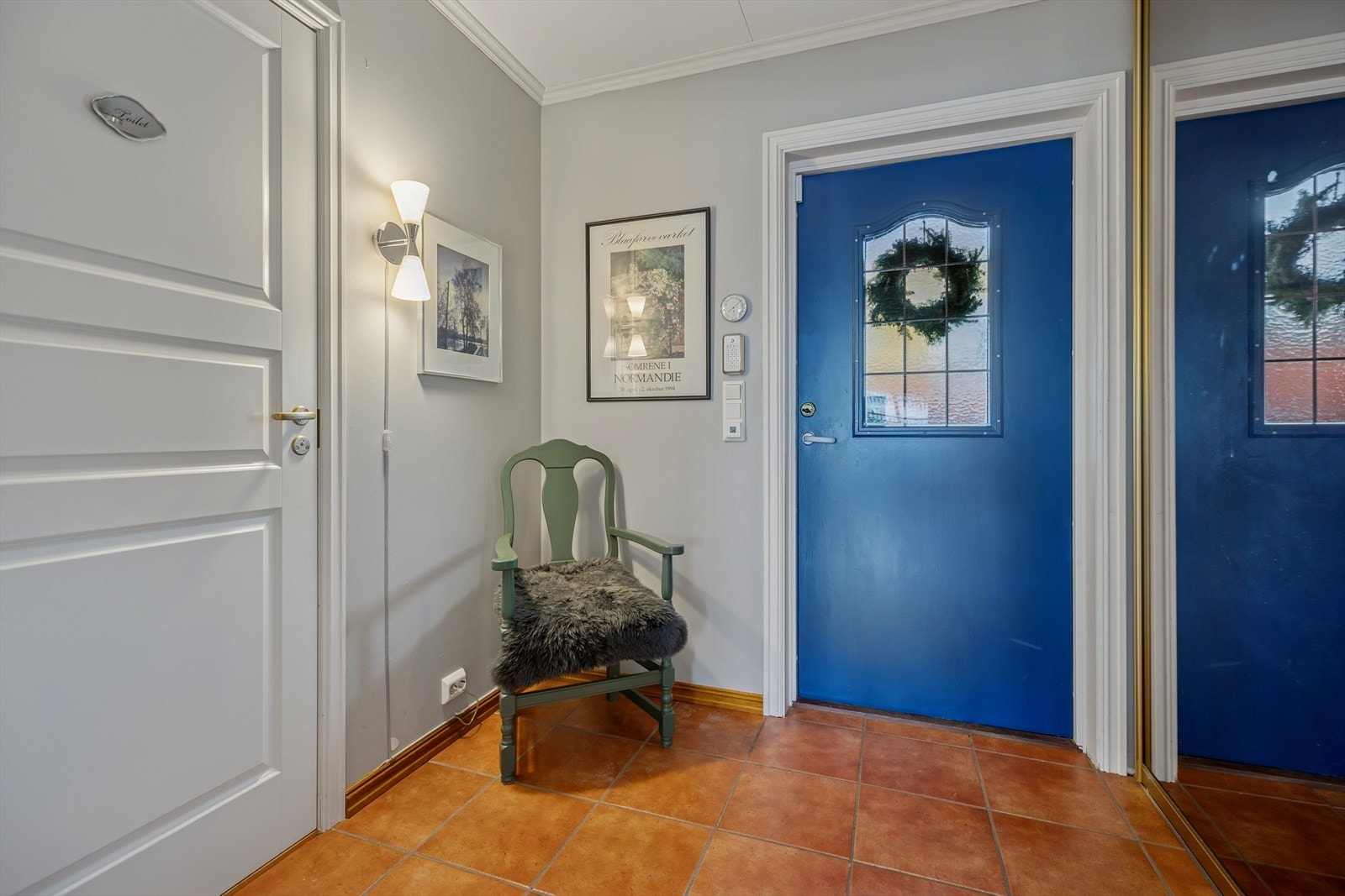 Romslig entré med skyvedørsgarderobe - døren til venstre leder inn til gjestetoalett/wc Galleribilde