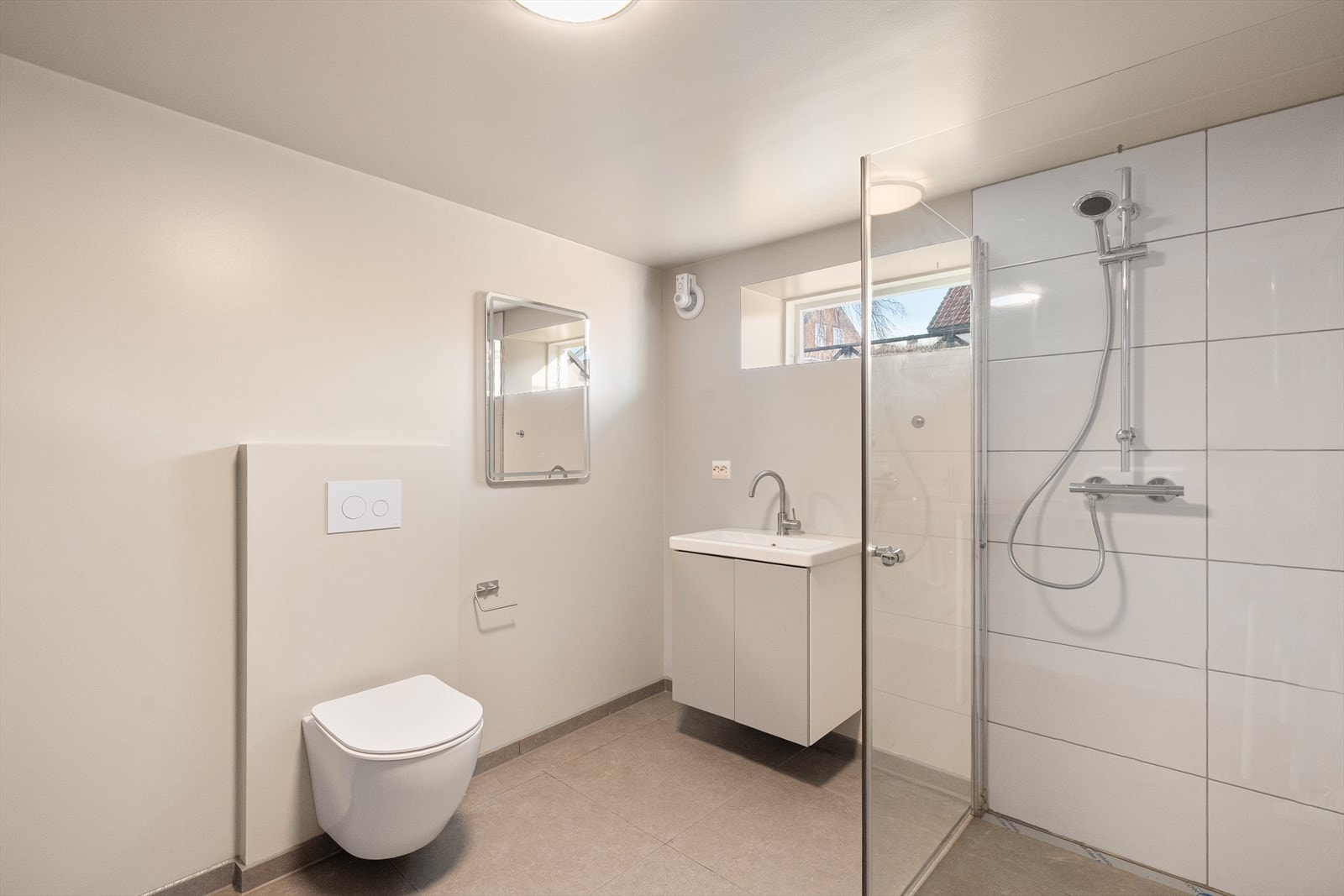 Vaskerommet er itillegg utstyrt med servantskap med overliggende servant, veggmontert toalett og en romslig dusj med glassvegg. Galleribilde