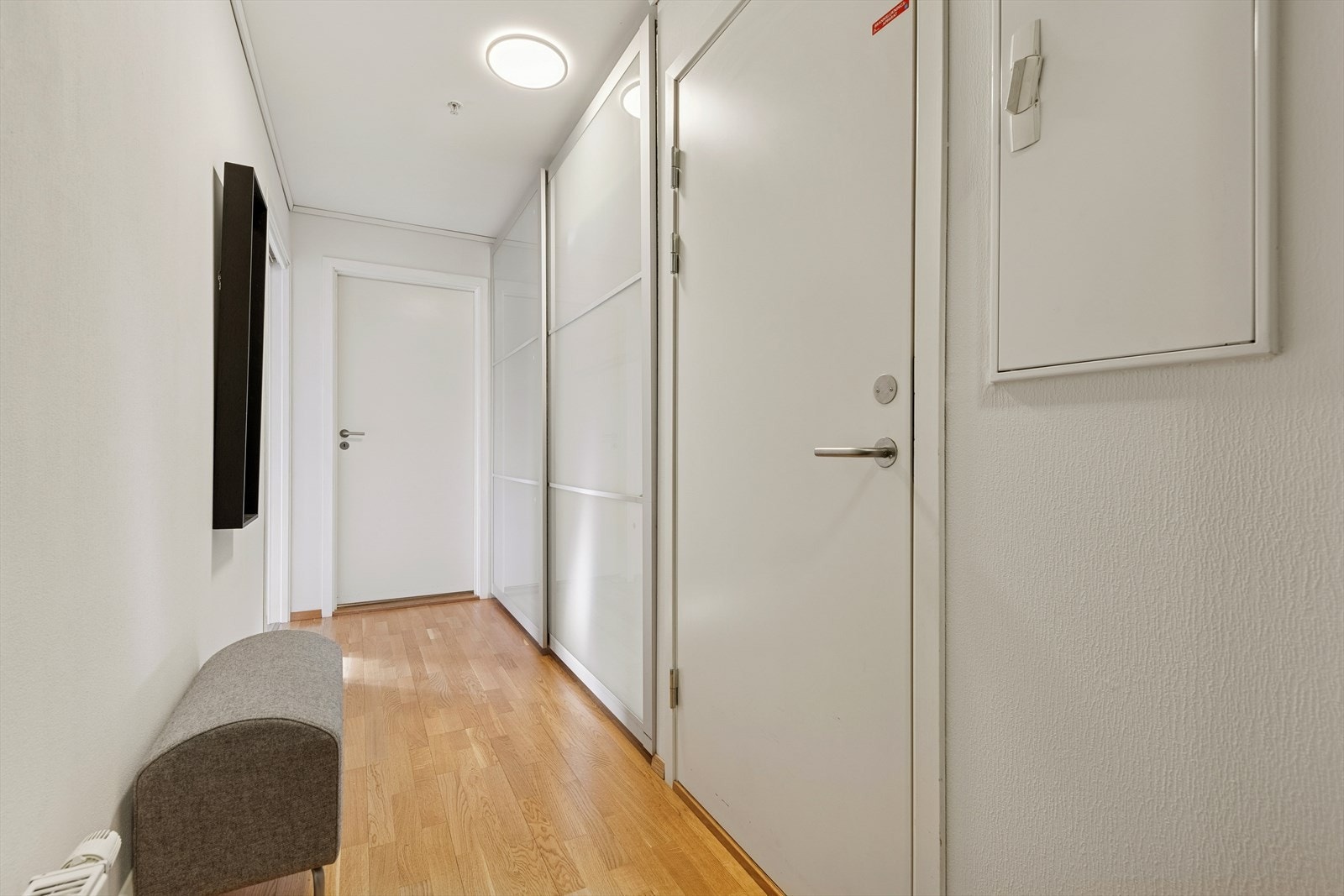 Gangen er utstyrt med skyvedørsgarderobe som gir effektiv oppbevaringsplass. Galleribilde