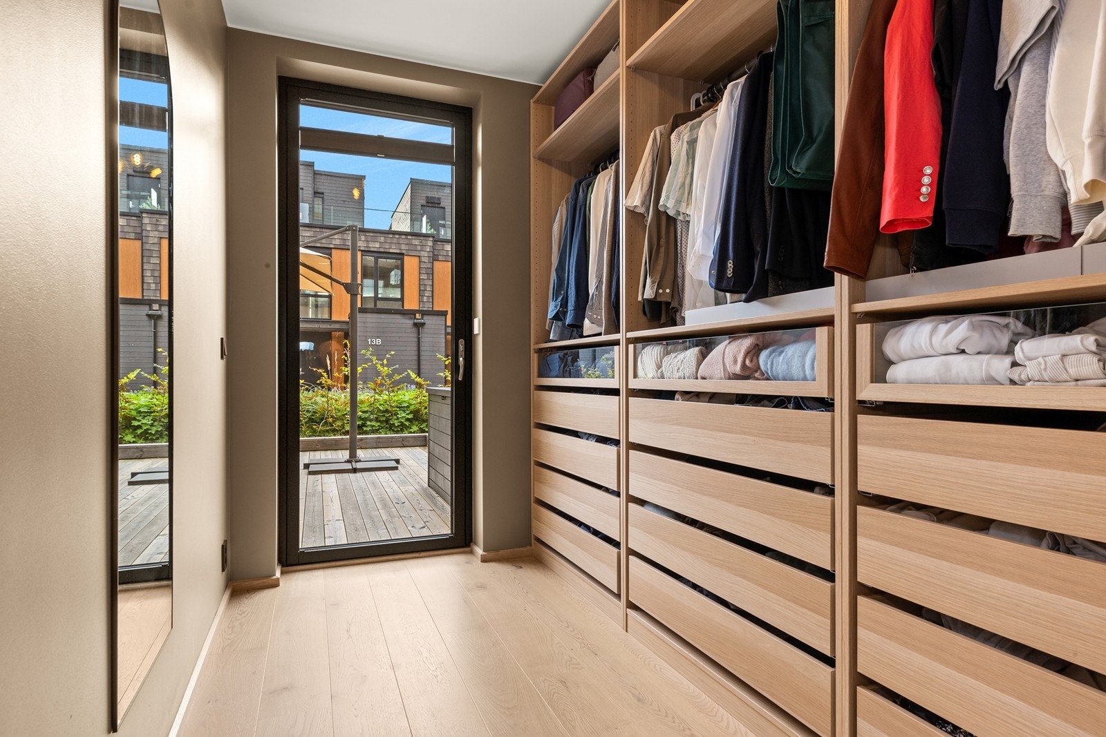 Det tredje soverommet er i dag innredet som et praktisk garderoberom med innholdsrik, åpen løsning og direkte utgang til terrassen. Galleribilde