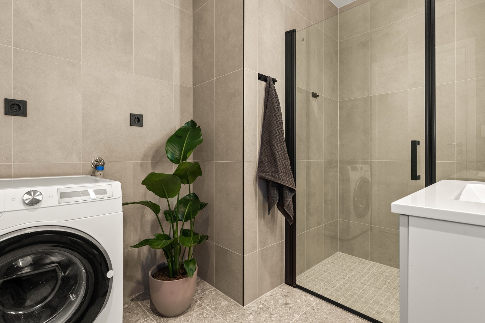 Her er det opplegg og plass til vaskemaskin, samt et praktisk dusjhjørne. Galleribilde