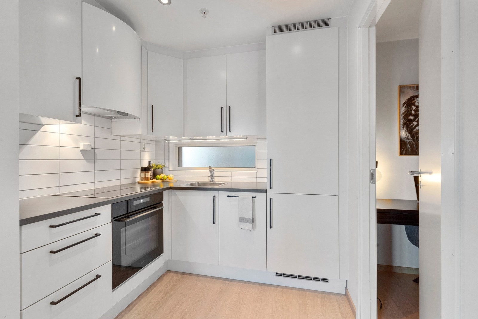 Kjøkkenet har integrert platetopp, stekeovn, oppvaskmaskin og kjøl/fryseskap. Galleribilde