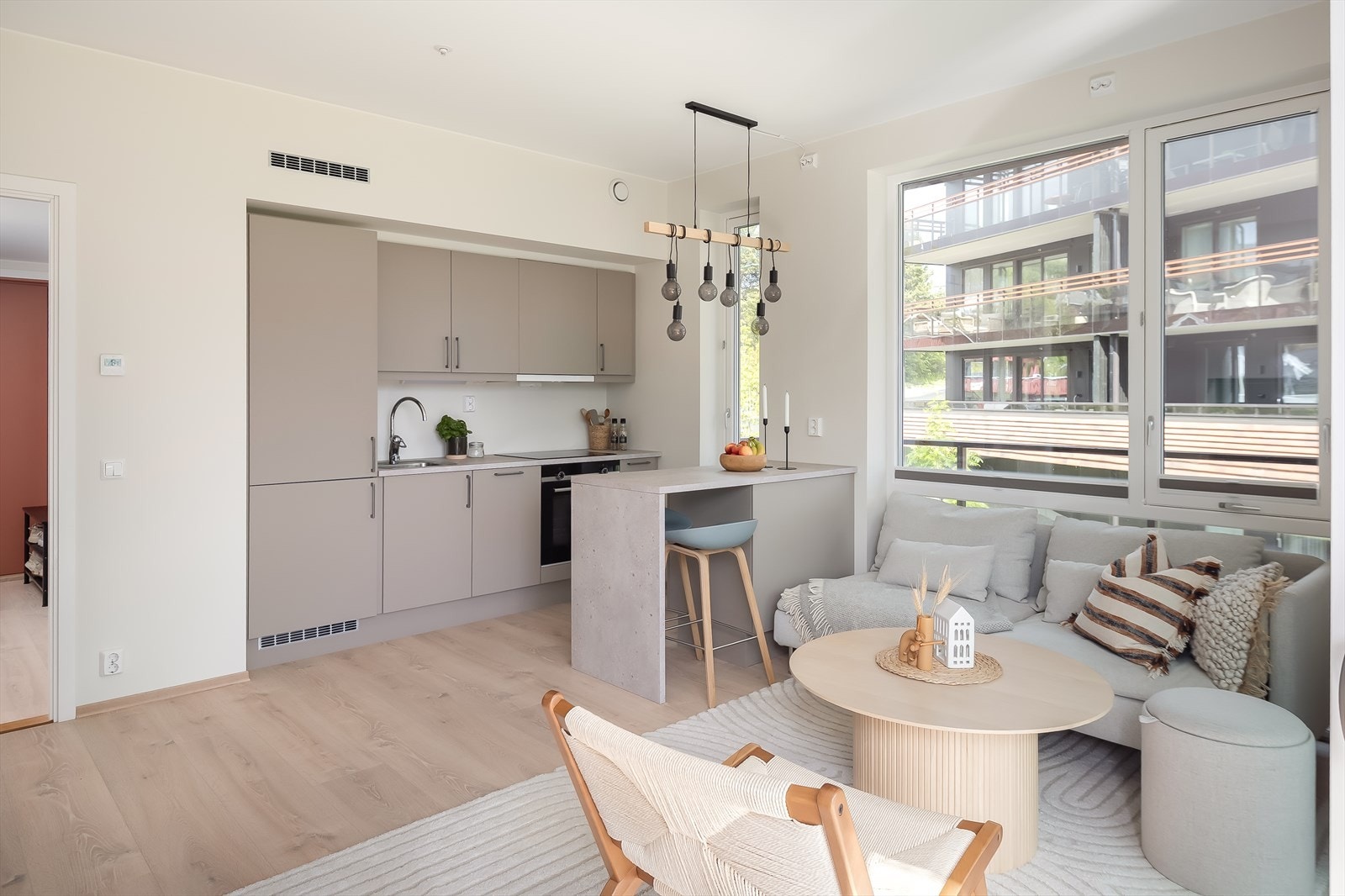 Leiligheten har et lyst og stilrent kjøkken, utstyrt med kjøkkenbar. Galleribilde