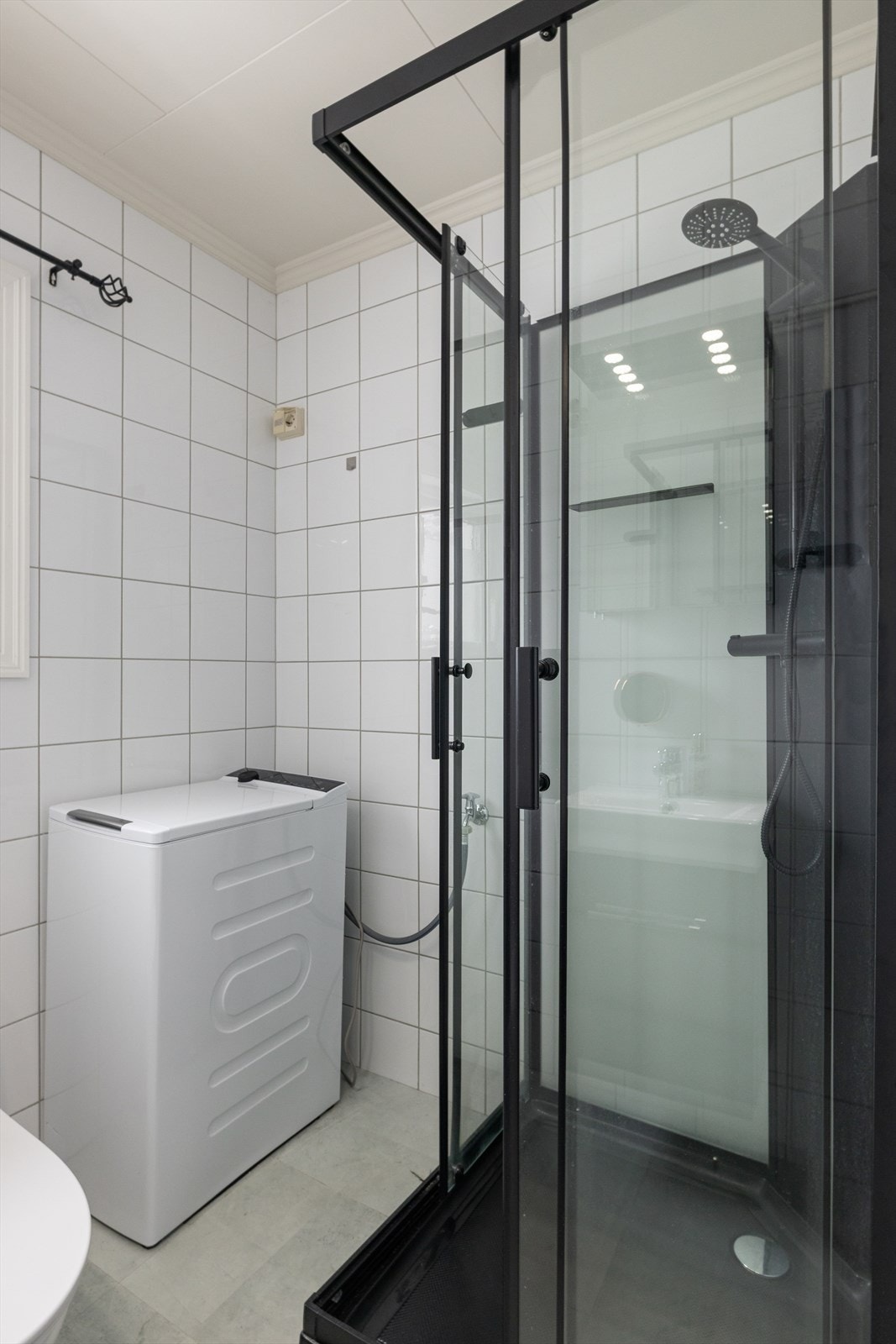 Badet er innredet med wc, servant, dusjkabinett og opplegg for vaskemaskin. Galleribilde