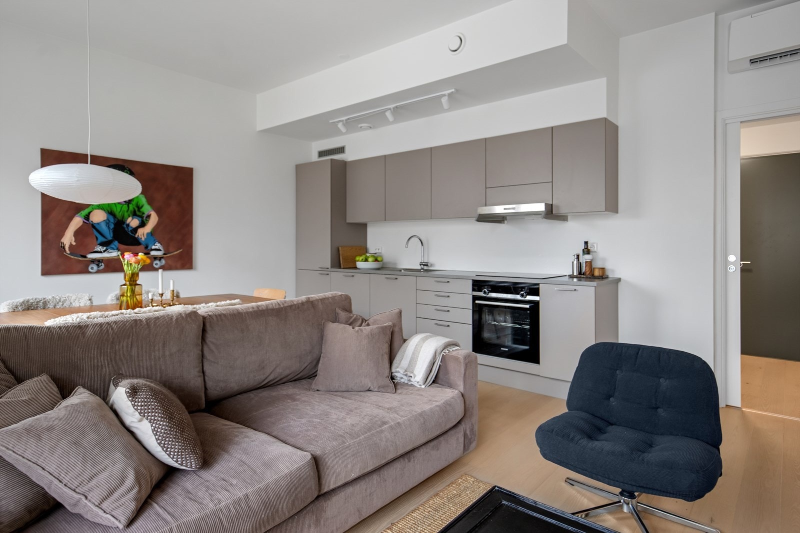 Gjennomgående i leiligheten er lys, enstavs parkett på gulv og lysmalte veggflater med listefrie overganger til tak og svært god takhøyde. Galleribilde