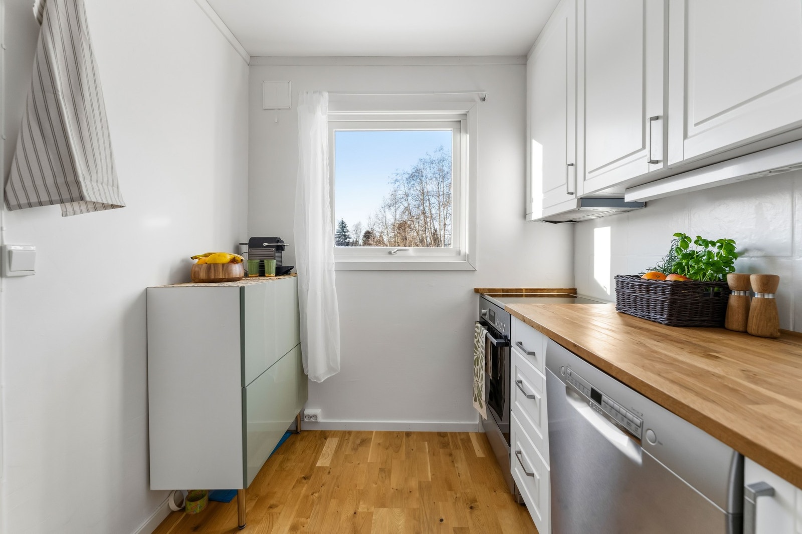 Det store vinduet slipper inn rikelig med naturlig lys og gir gode arbeidsforhold. Innredningen er senere utvidet med smalt benkeskap og veggskap med moderne, slette fronter. Galleribilde