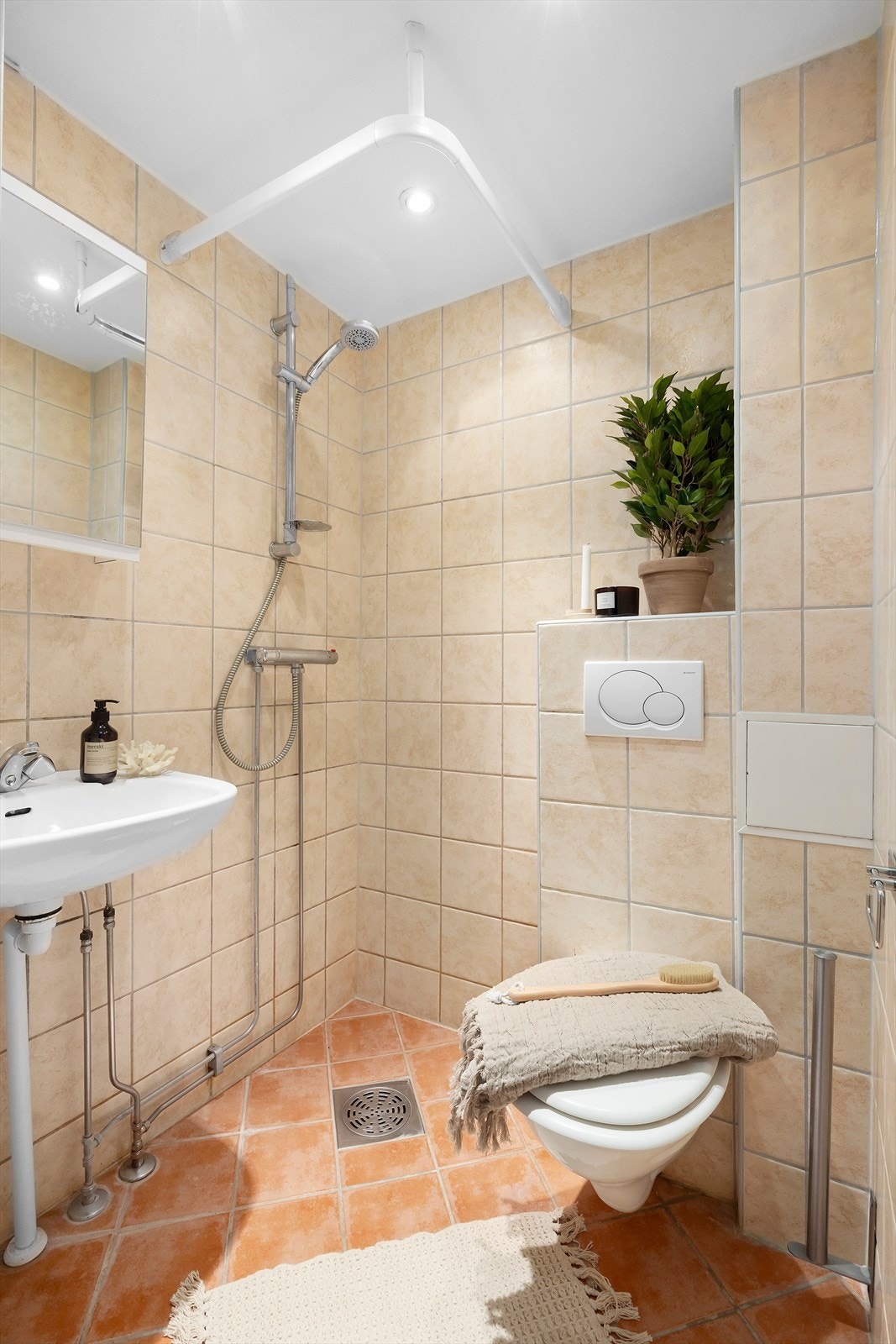 Flislagt bad med gulvvarme innredet med servant og ettgreps blandebatteri, vegghengt toalett samt praktisk dusjhjørne. Badet er rehabilitert i regi av sameiet i 2006/2007. Galleribilde