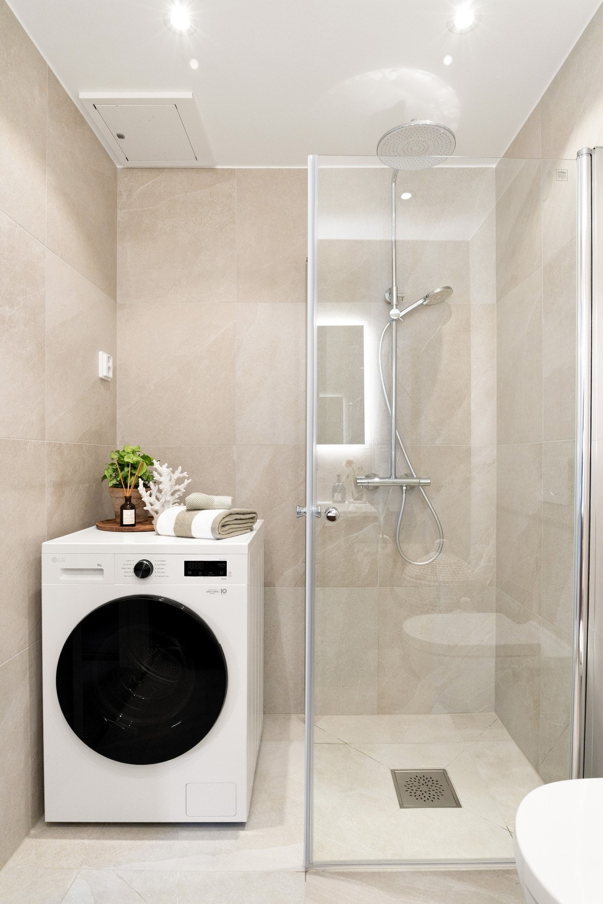 Dusjhjørne med glassdører og opplegg til vaskemaskin og evt tørketrommel. Galleribilde