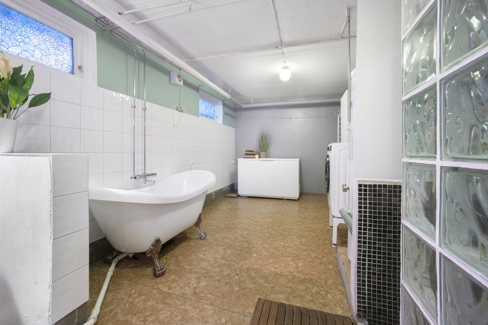 Vaskerom/teknisk rom er utstyrt med dusjnisje, badekar og opplegg for vaskemaskin Galleribilde