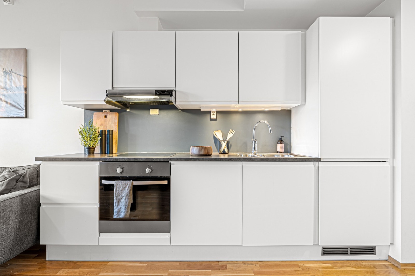 Over benkeplaten på kjøkkenet har du spotter. De integrerte hvitevarene medfølger i handelen og inkluderer platetopp, stekeovn, kjøl/fryseskap og oppvaskmaskin. Galleribilde