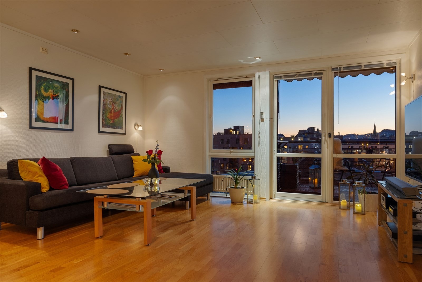 Romslig stue med parkett på gulv, downlights i himling og utgang til balkong. Galleribilde