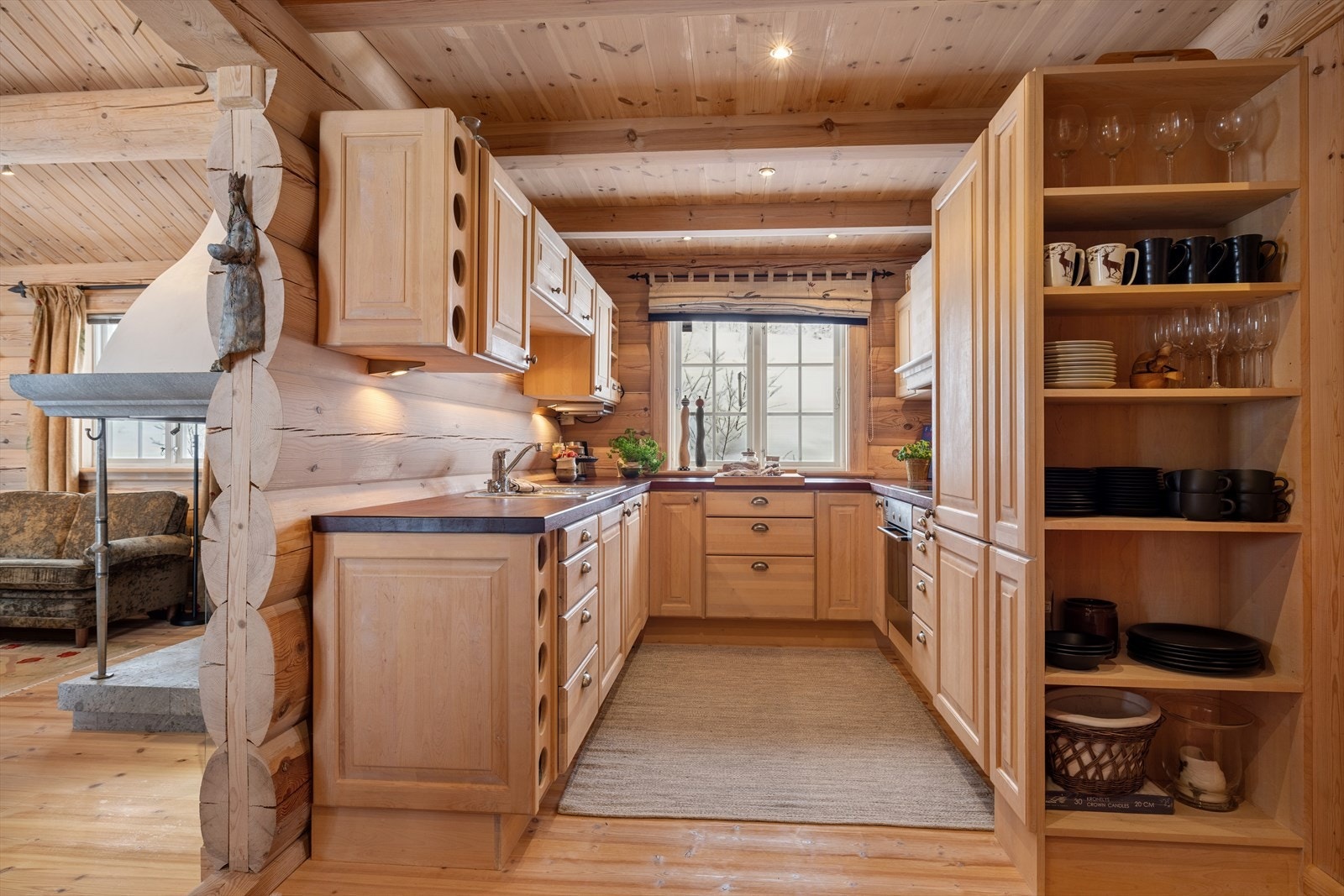 Laftet tømmer og treverk skaper en varm atmosfære der måltidene blir en del av hyttestemningen. Galleribilde