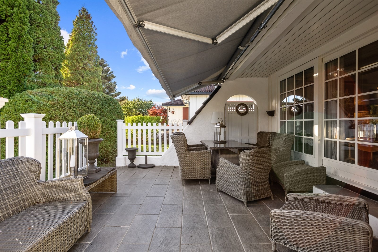 Hovedterrassen ligger orientert mot syd, langs fronten av huset. Denne ca. 19 m² skjermende uteplassen med flislagt dekke, plassert godt opp fra hageterrenget, blir nærmest som en "ekstra stue" i sommerhalvåret. Galleribilde