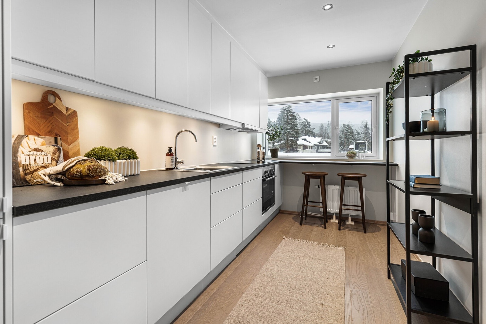 Stilrent kjøkken med slette flater og optimal utnyttelse av lagringsplass Galleribilde