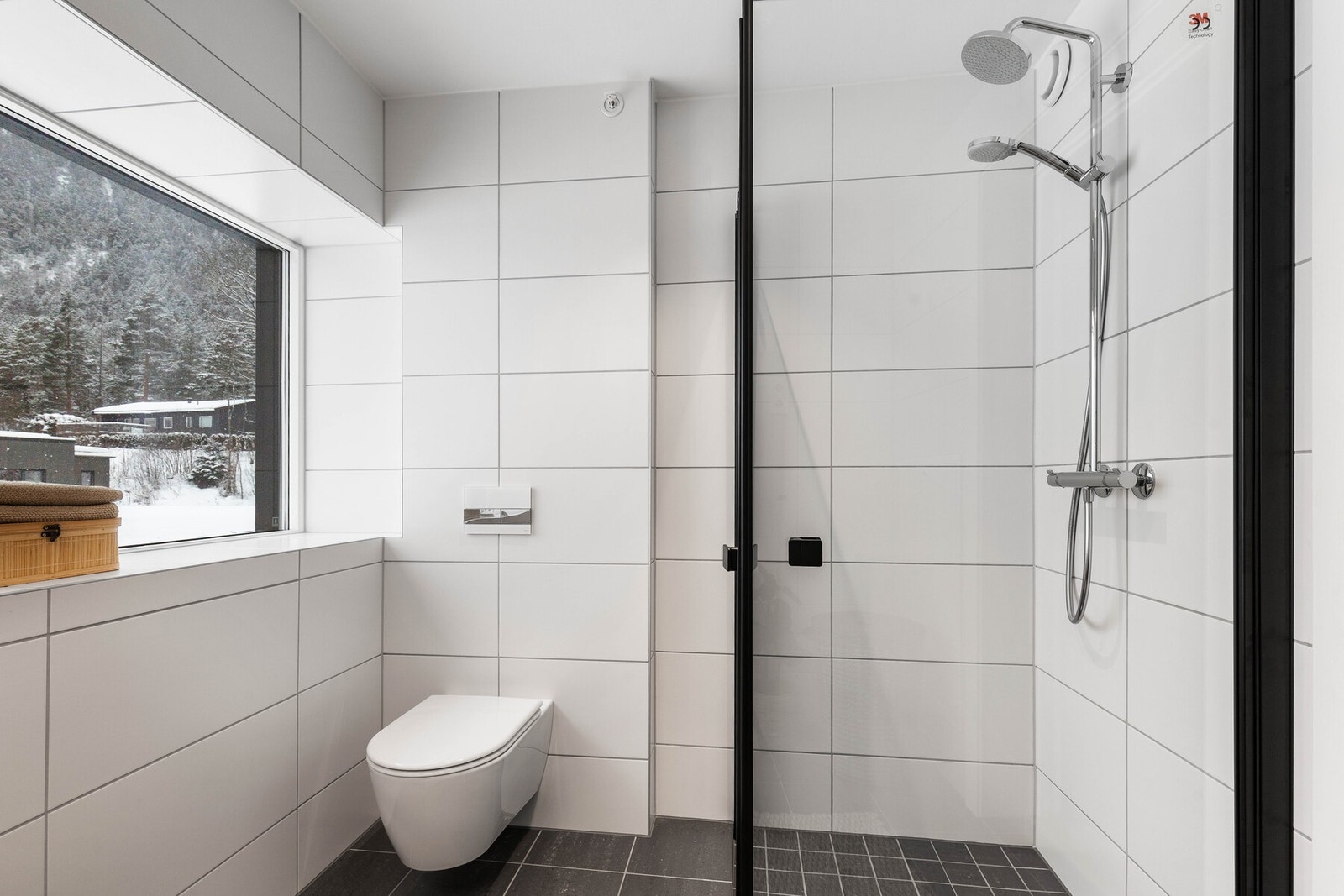 Badet preges av moderne detaljer, inkludert regndusj og vegghengt toalett Galleribilde