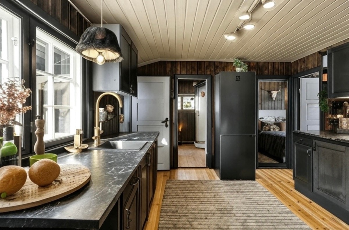 Kjøkkeninnredning med profilerte fronter i dempet sort. Galleribilde