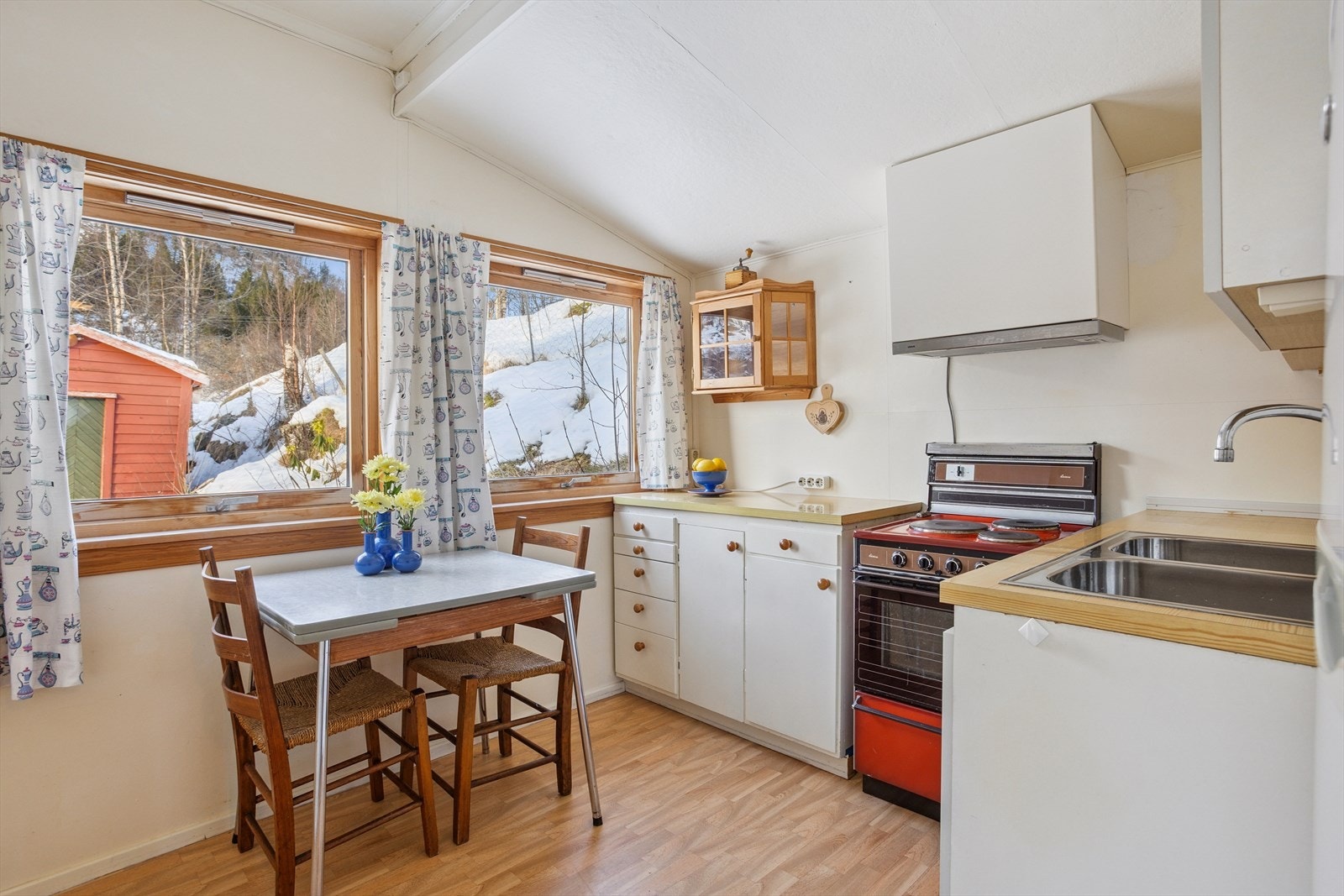 - Kjøkkenet har kjøkkeninnredning med slette fronter og benkeplate av laminat. Her har du også god plass til et hyggelig frokostbord - Galleribilde