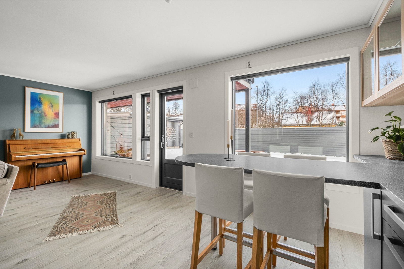 De store vindusflatene strekker seg langs hele veggen som gir rommet en åpen og luftig atmosfære Galleribilde