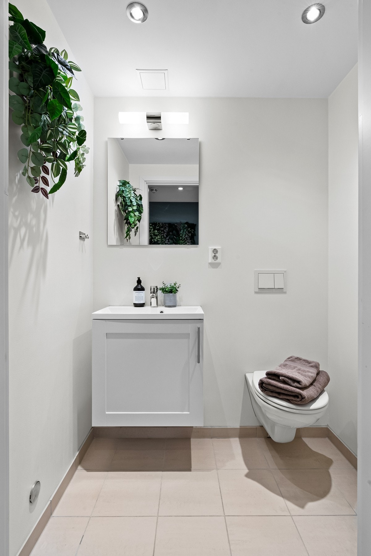 Toalettrom med downlights i himling, gulvvarme og beige gulvfliser Galleribilde