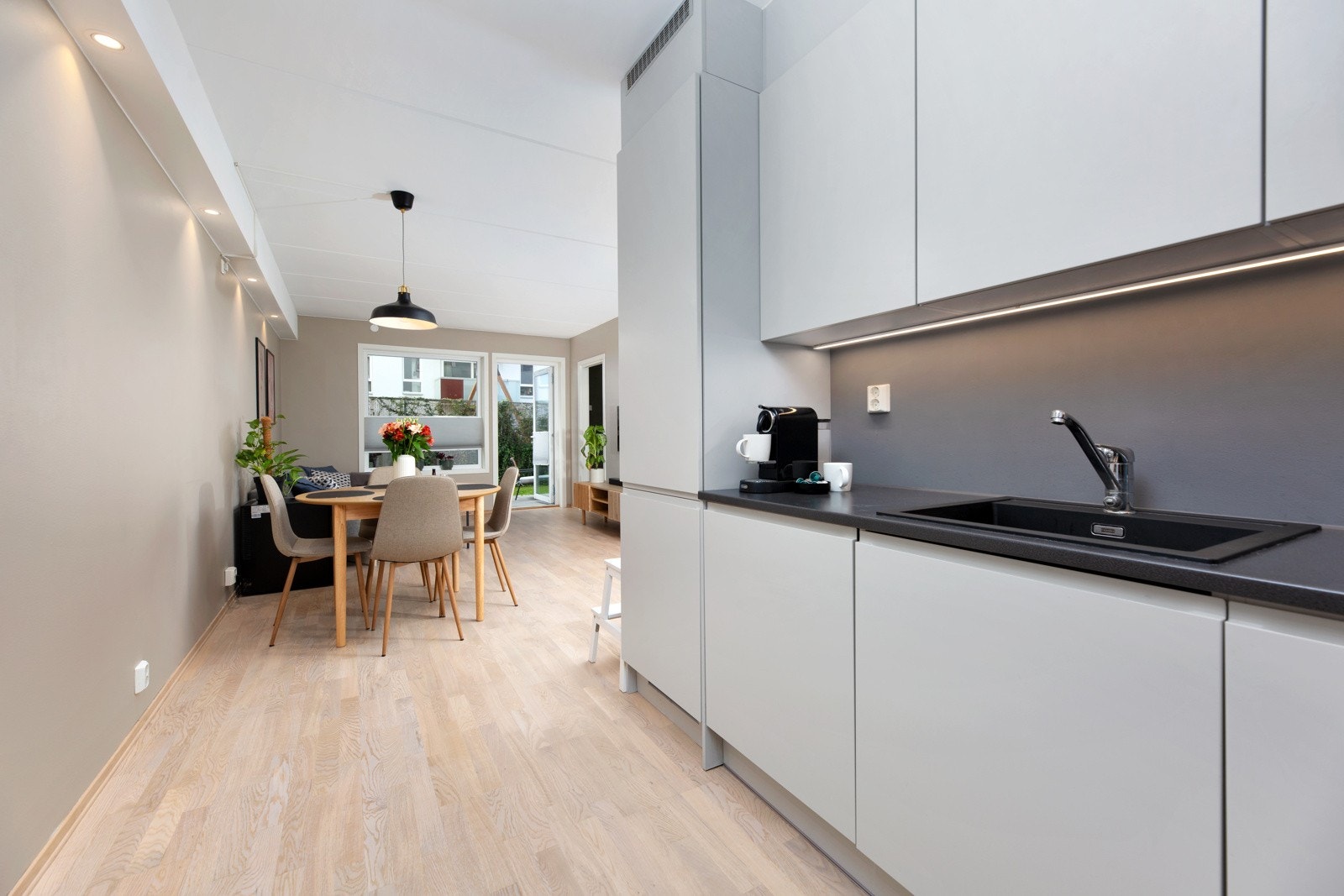 Integrerte hvitevarer som stekeovn, nedfelt induksjonstopp, oppvaskmaskin og kjøleskap med frysedel følger med. Galleribilde