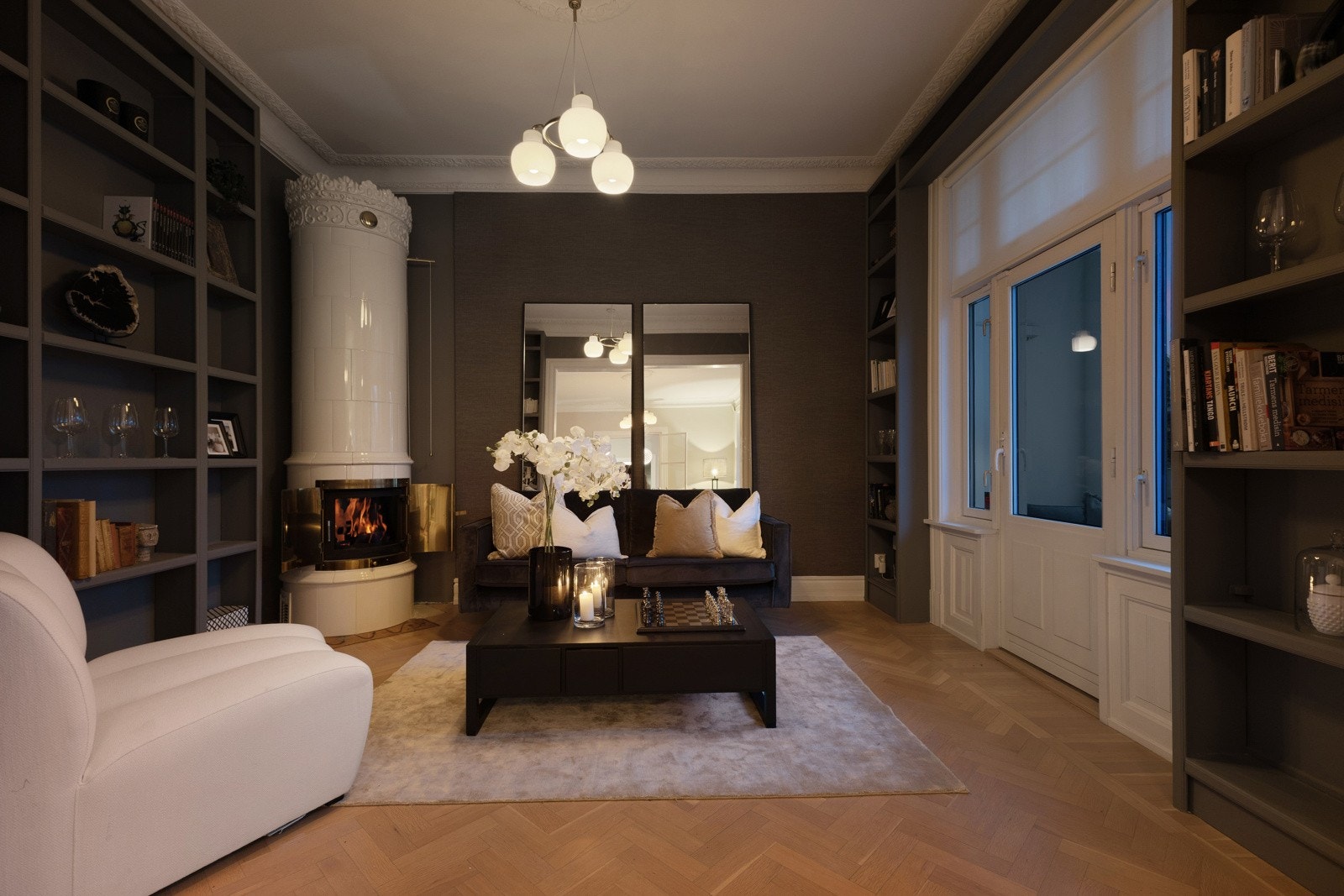 Eksklusivt bibliotek med plassbygde hyller og stemningsfull svensk kakkelovn. Galleribilde