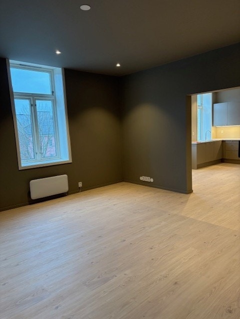 Romslig stue som er lett å møblere. Stor døråpning inn til kjøkkenet. Galleribilde