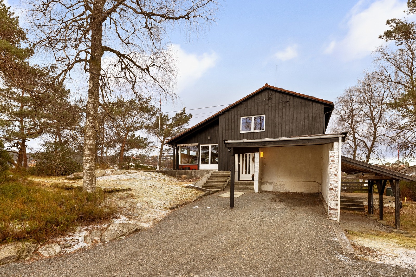 Det er godt med parkeringsplass i carport og ellers på tomten. Galleribilde