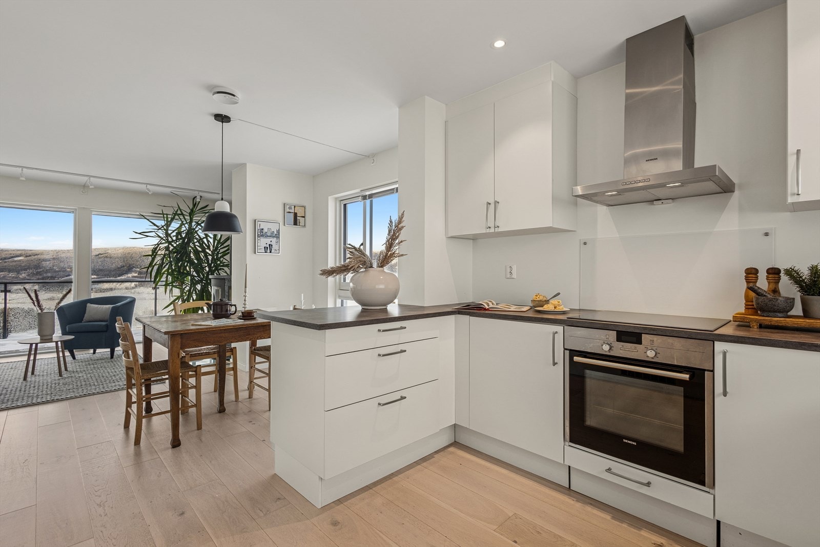 Pent og lyst kjøkken med tilrettelagt plass for integrert steketopp, komfyr, oppvaskmaskin og kjøleskap/fryseskap. Galleribilde