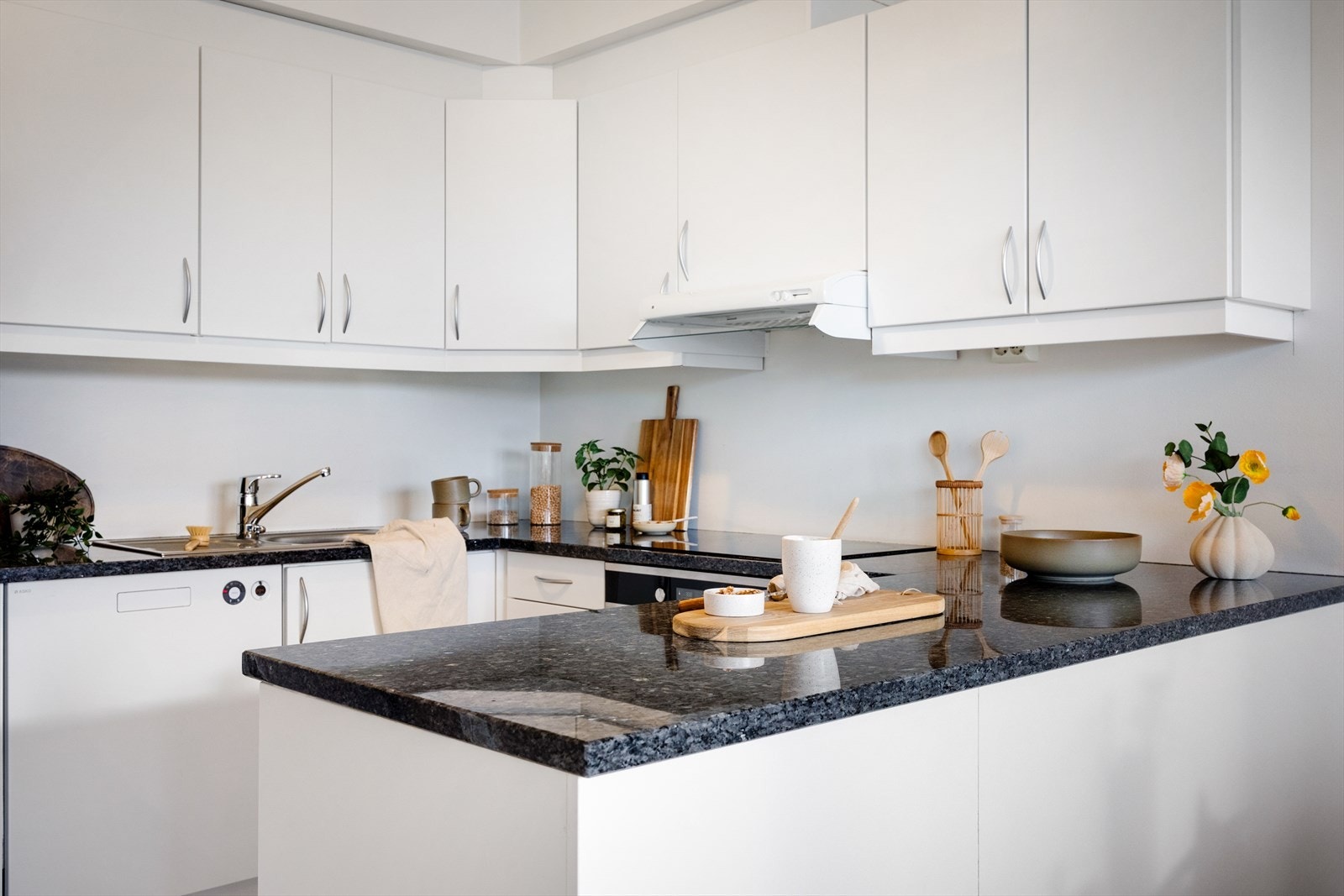 Kjøkkeninnredningen er utstyrt med benkeplate av granitt, nedfelt stålvask, glatte fronter og opplegg for oppvaskmaskin. Galleribilde