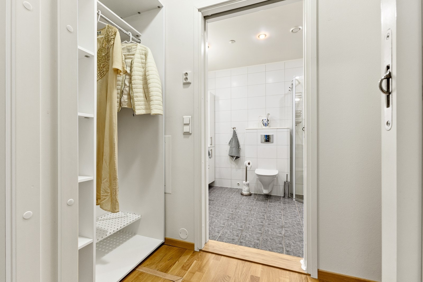 I overgangen mellom hovedsoverom og privat bad er det etablert en funksjonell garderobeløsning. Skyvedører mellom rommene bidrar til effektiv arealutnyttelse der verdifull veggplass ikke går tapt. Galleribilde