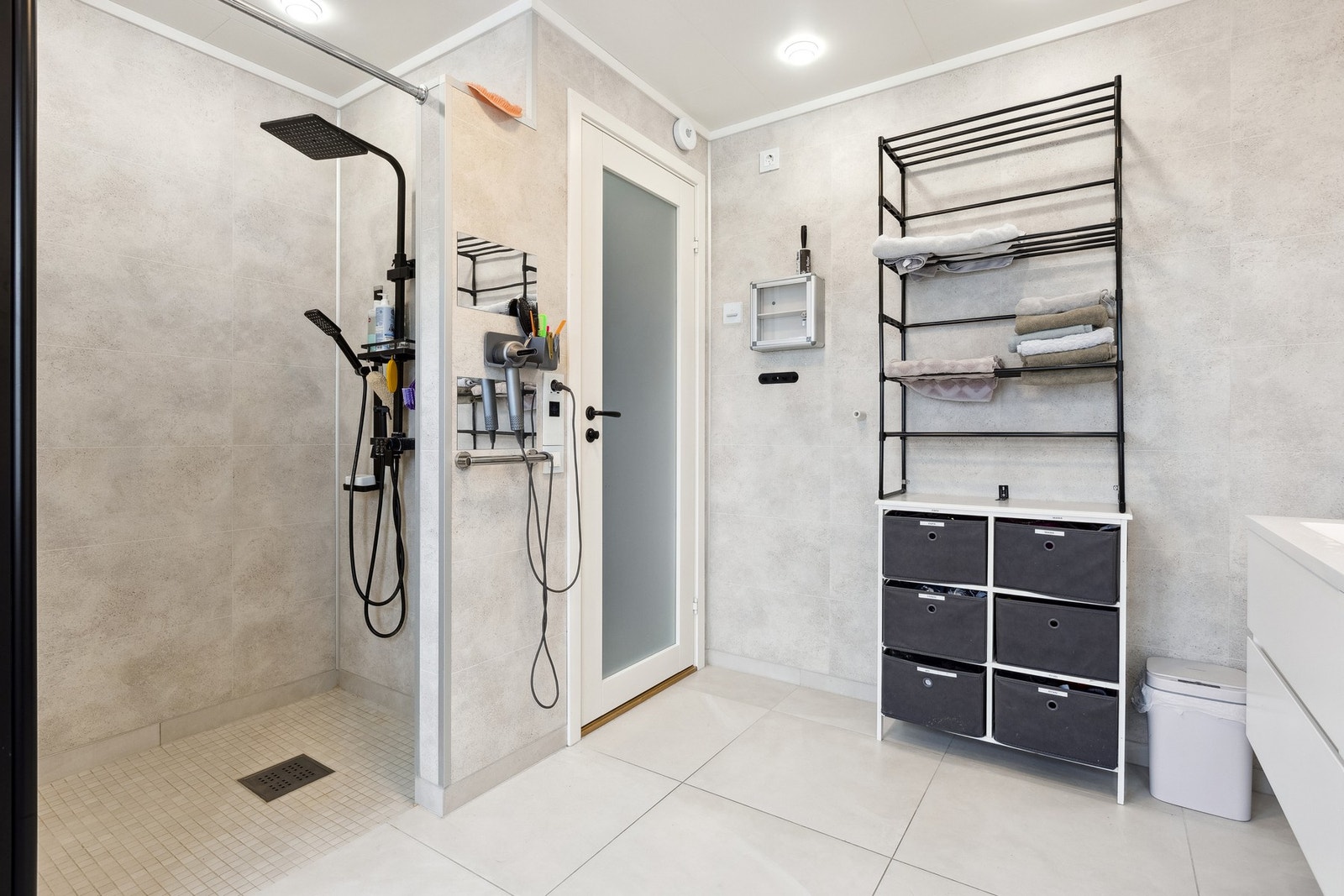 God plass til dusjing i egen dusjnisje. Mosaikkfliser på gulvet og moderne baderomsplater på vegg. Galleribilde