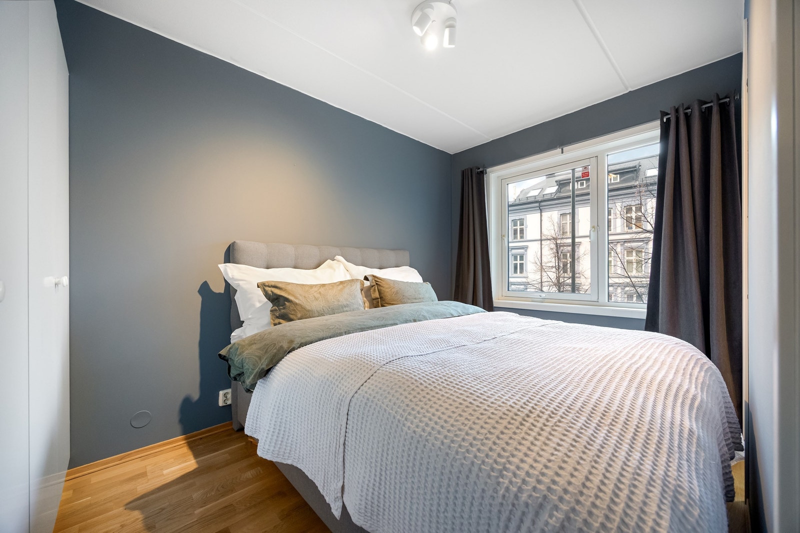 Romslig soverom med plass til stor dobbeltseng, nattbord og garderobeskap. Galleribilde