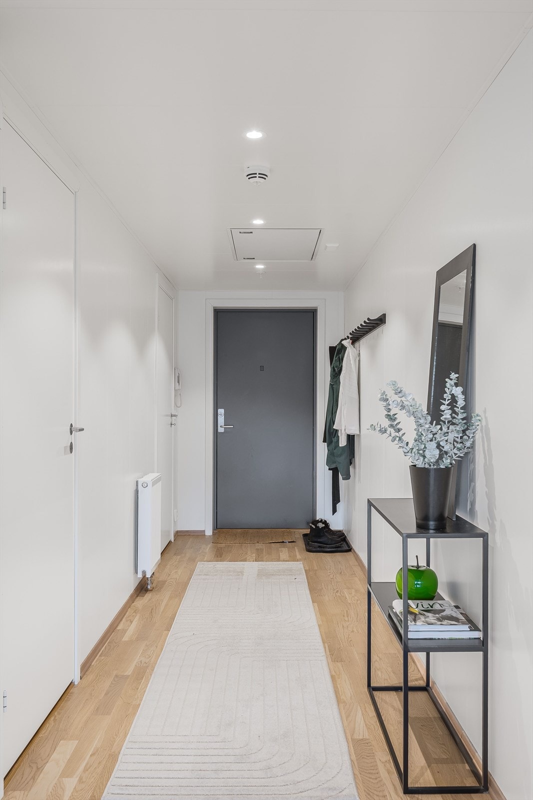 Leiligheten har en entré med plass for opphengsløsninger for tøy. Fra entréen er det to dører inn til soverommet, som ligger vendt mot øst. Galleribilde