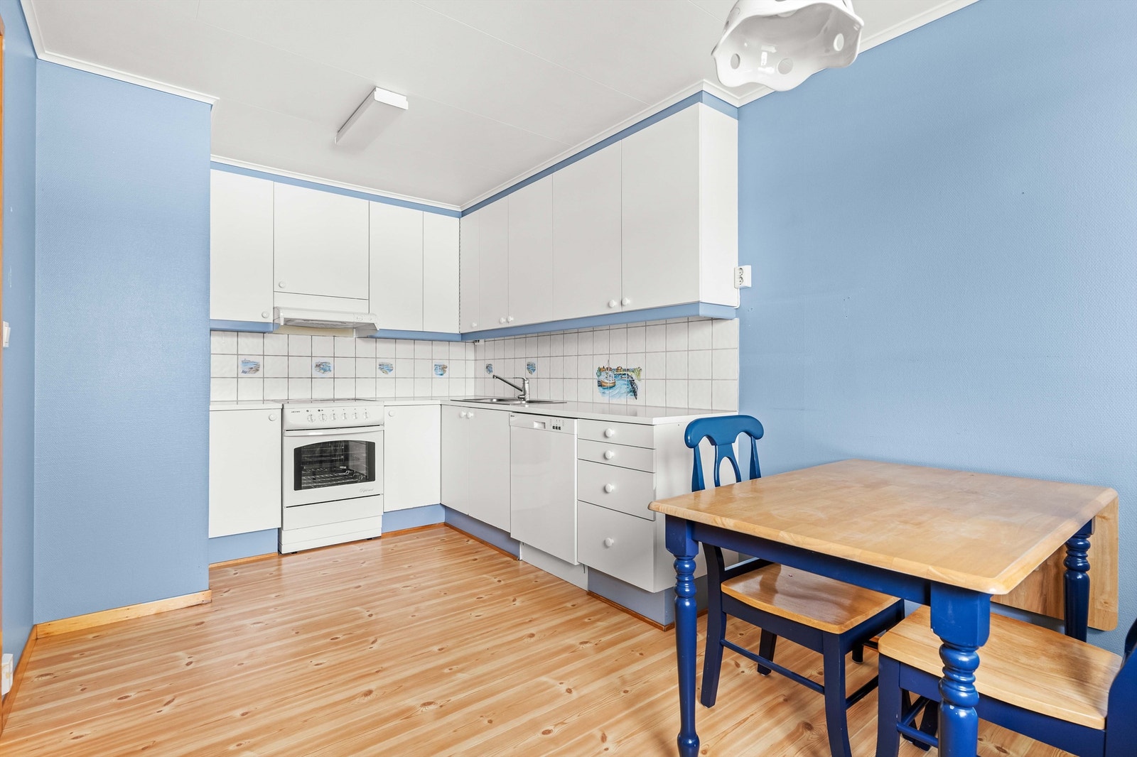 Kjøkkeninnredning med hvite glatte fronter fra byggeår. Galleribilde