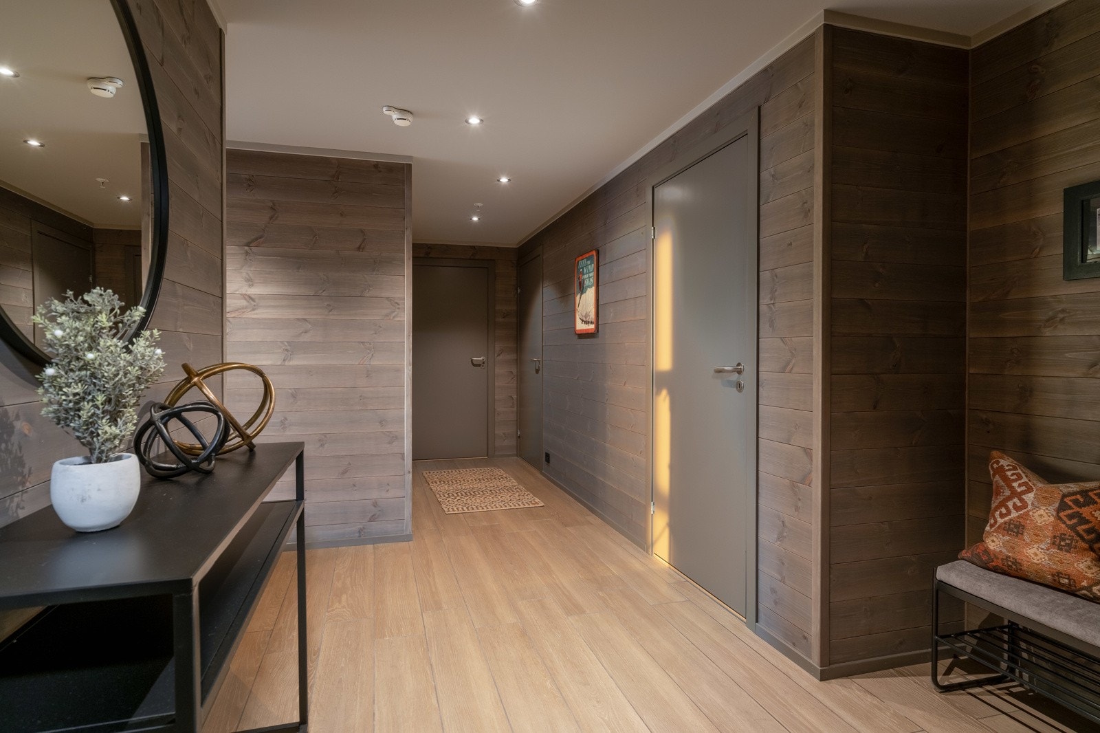 Romslig og innbydende entré med parkettlignende fliser på gulv, vannbåren gulvvarme og downlights. Galleribilde