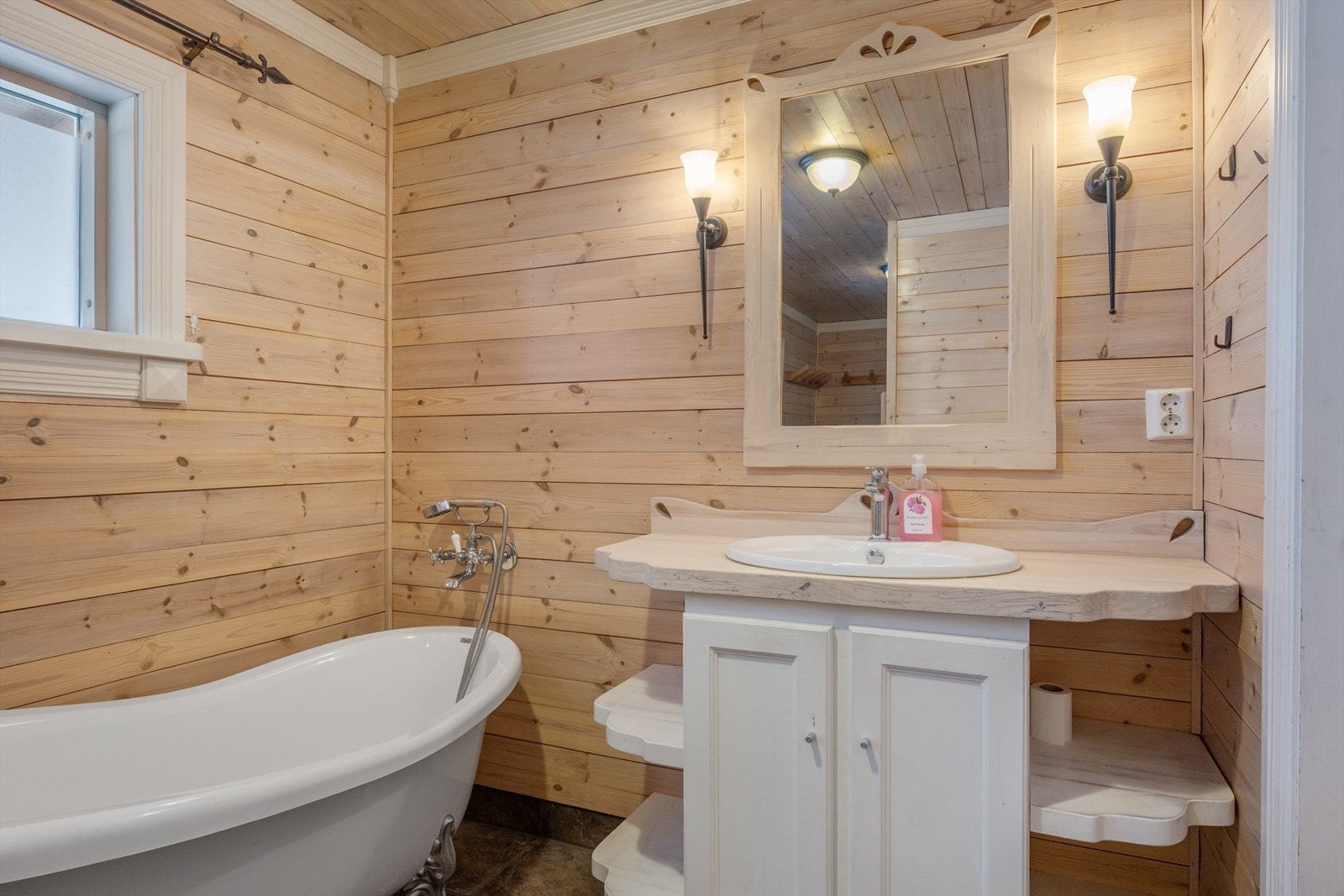 Interiøret består av lys innredning, badekar og gulvmontert wc. Galleribilde