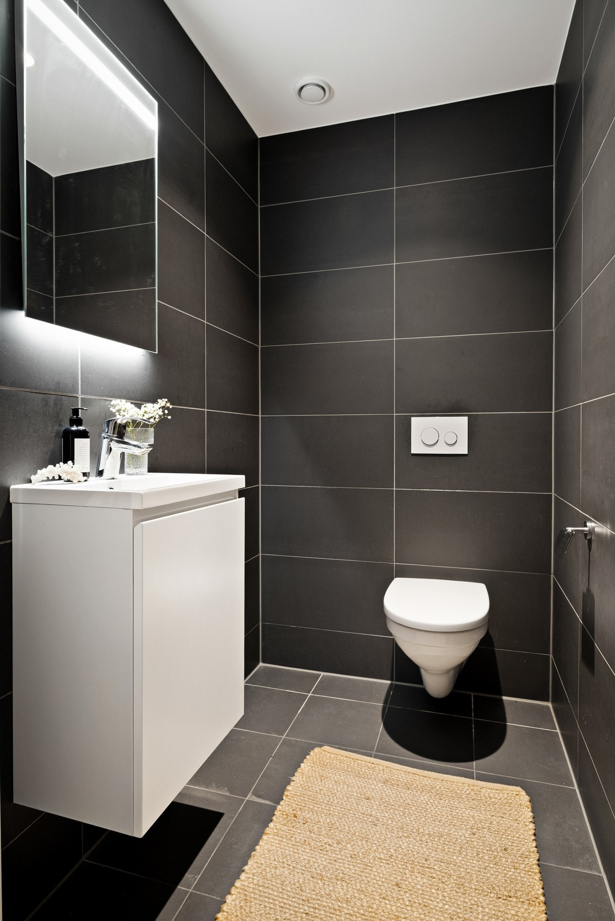 Flislagt, separat toalettrom med servant over baderomsskap. Speilskap. Galleribilde