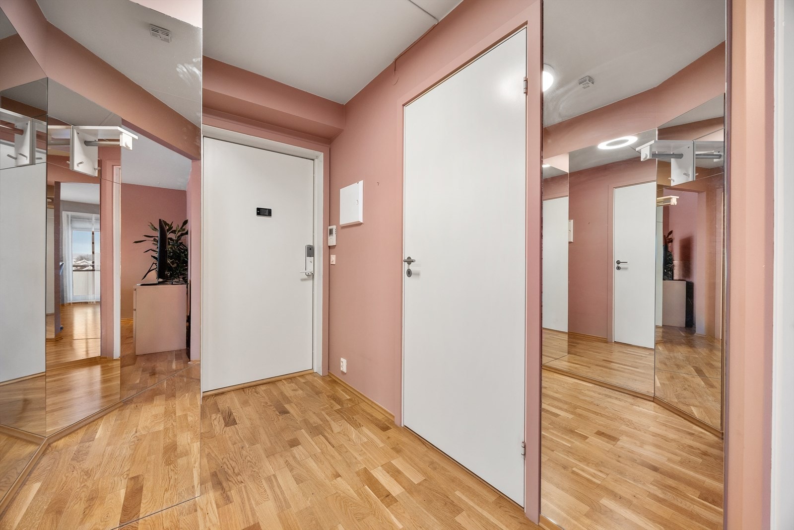 Romslig entré med god plass til oppbevaring i en skyvedørsgarderobe med speilfronter. Galleribilde